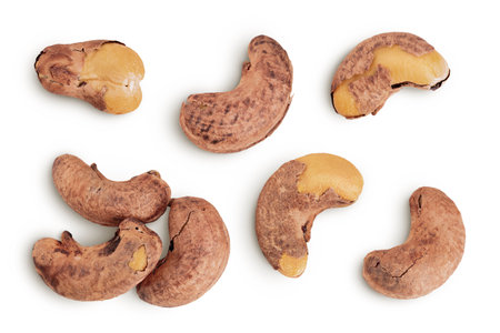 cashew nuts heap with shell isolated on white background. Top view. Flat layの写真素材