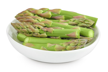 fresh asparagus in ceramic bowl isolated on white backgroundの写真素材