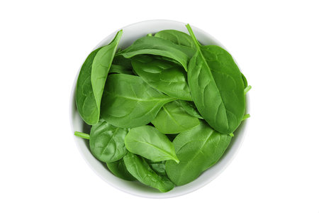 Baby spinach leaves in ceramic bowl isolated on white background. Top view. Flat layの写真素材