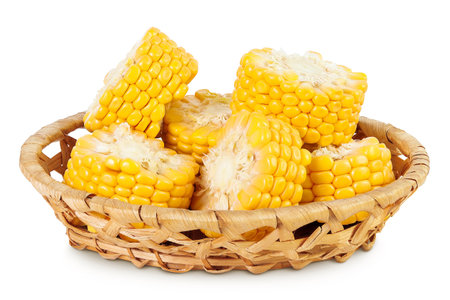 ear of corn in a wicker basket isolated on a white background with full depth of fieldの写真素材