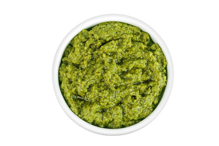 Pesto sauce in ceramic bowl isolated on white background. Top view. Flat layの写真素材