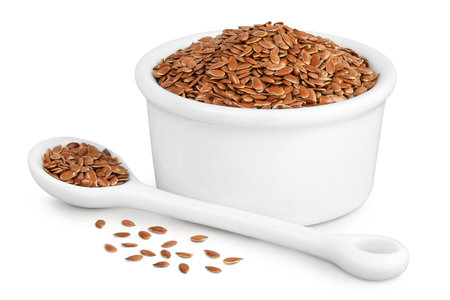 flaxseed in ceramic bowl isolated on white background. Top view. Flat layの写真素材