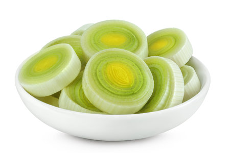 sliced Leek vegetable in ceramic bowl isolated on white background with full depth of fieldの写真素材