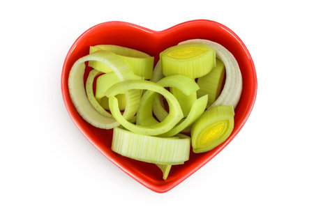 sliced Leek vegetable in ceramic bowl isolated on white background. Top view. Flat layの写真素材
