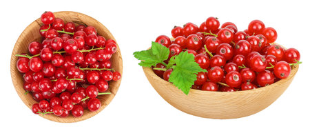 Red currant berries in a wooden bowl isolated on white background. Top view. Flat layの写真素材