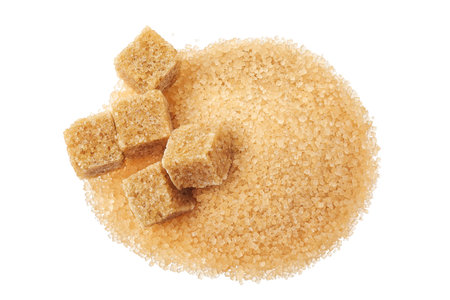 Pile of brown granulated sugar and sugar cubes isolated on white background. Top view, flat lay.の写真素材