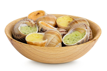 escargot snail filled with different fillings in wooden bowl isolated on white backgroundの写真素材