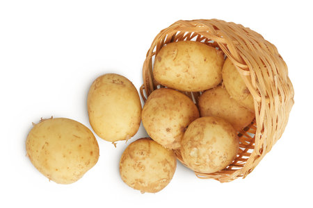 young potato in a wicker basket isolated on white background. Harvest new. Top view. Flat lay.の写真素材