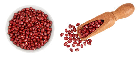 Red adzuki beans in ceramic bowl and wooden scoop isolated on white background. Top view. Flat lay.の写真素材