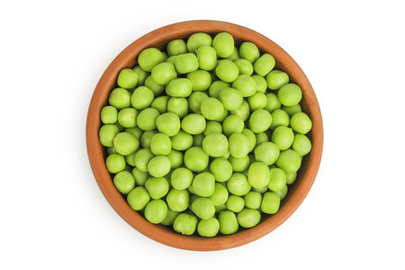 Fresh green peas in bowl isolated on white background. Top view. Flat layの写真素材
