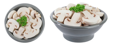 Fresh mushroom champignon slices in a ceramic bowl isolated on white background. Top view. Flat layの写真素材