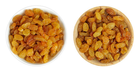 Yellow Raisins in ceramic bowl isolated on white background. Top view. Flat layの写真素材