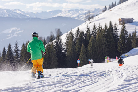 man and woman skiing and snowboarding in the mountains, ski resortの写真素材