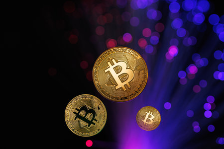 Glowing Bitcoin cryptocurrency against the background of fiber optic cables. Bitcoin digital cryptocurrency consisting of dots and lines, cryptocurrency mining. cryptocurrency exchangeの写真素材