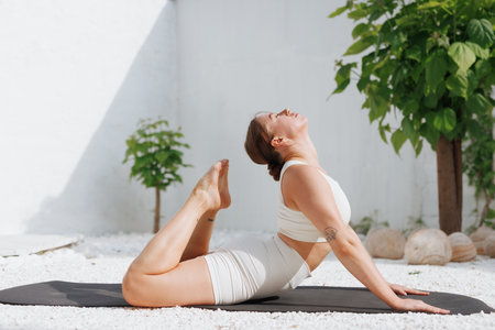 yoga stretching outdoors. side view of overweight woman practicing yoga on white background, body...