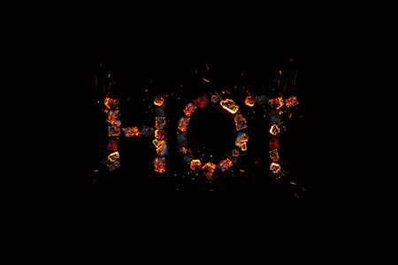 the hot word on a dark background is laid out from burning coals, the concept of burning discountsの写真素材