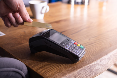 NFC credit card payment. Woman paying with contactless credit card with NFC technology. Wireless...