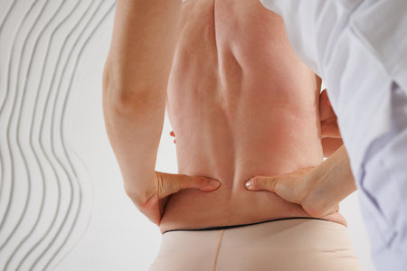 a therapist rehabilitation specialist checks the mobility of the spinal arches. Evaluation of the...