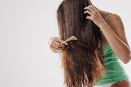 Beauty Hair Care. Beautiful Woman Combing Long Natural Hair, hair care, hair problemの写真素材
