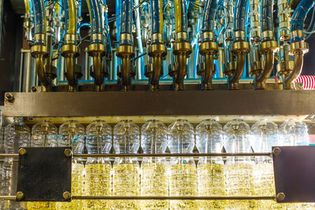 Automated sunflower oil filling line with transparent bottles and industrial machinery in a modern...