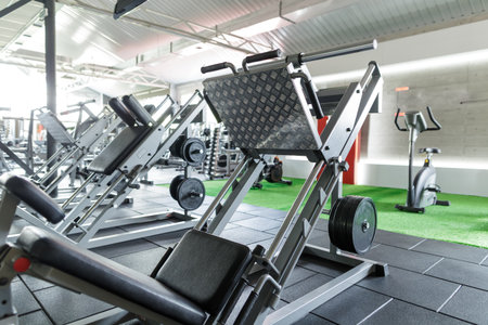 Modern gym with leg press machine and strength training equipment for fitness, bodybuilding, and...
