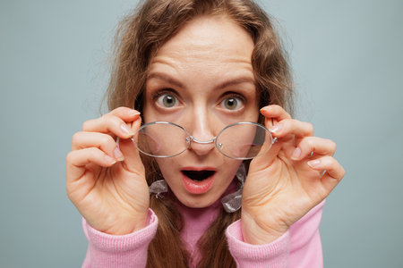 Happy young woman in glasses amazed by clear vision, eye health and correction, stylish portrait...