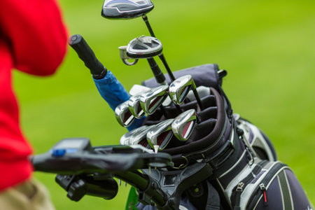 Closeup of golf clubs in bag on green field outdoor sports equipment for professional game training or tournamentの写真素材