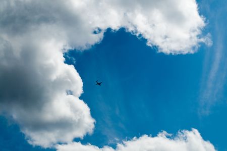 The bright beautiful cloudy sky and the flying plane!の写真素材
