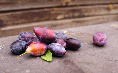 plum against a wooden wallの写真素材