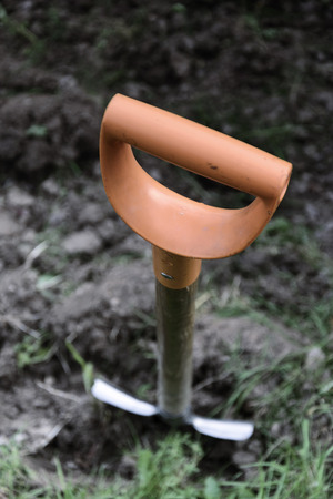 Soil with shovel in garden, focus on up of shovelの写真素材