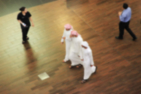 Arab sheikhs man in a mall make a purchase, Dubai, people go to the mall, market, blurred for backgrounddの写真素材