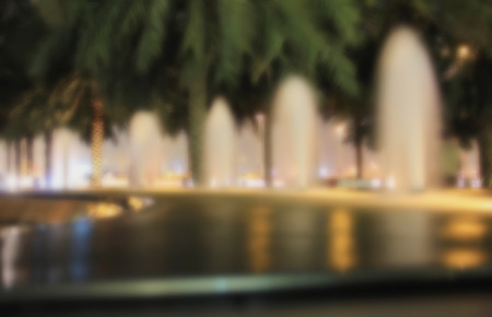 Blur blurred background street fountains, palm trees evening light for backgroundの写真素材