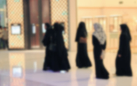 Arab woman walking through the mall, blurred for backgroundの写真素材
