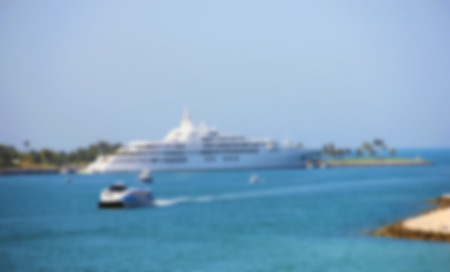 Luxury white yacht and the Burj Al Arab Hotel in Dubai,blurred for a background for greeting cardsの写真素材
