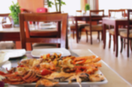 seafood grill in a large plate in a restaurant or cafe decorated table with food, blurredの写真素材