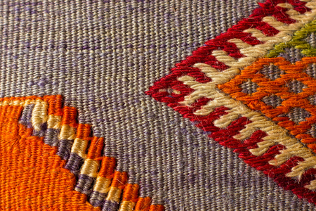 colorful handicraft style carpet made from natural materials that do not contain chemicals closeup.の写真素材