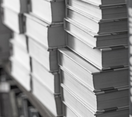 books on a shelf in the library, reading, and science education, stack of books piled volume hardcoverの写真素材