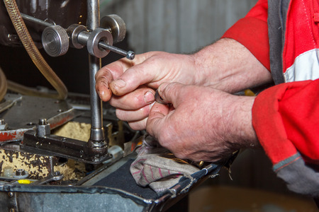 Professional mechanics testing diesel injector in his workshop, repair of diesel fuel injectors, ustroustvo for the diagnosis of fuel injectors soft focusの写真素材