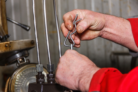Professional mechanics testing diesel injector in his workshop, repair of diesel fuel injectors,...