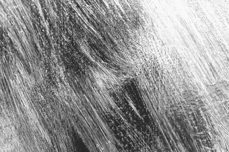 The texture of the green wall with scratches and brushstrokes of white paint, for background and designの写真素材