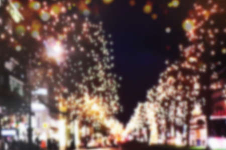 Blurry city streets with their Christmas decorations. Bokeh as background for design