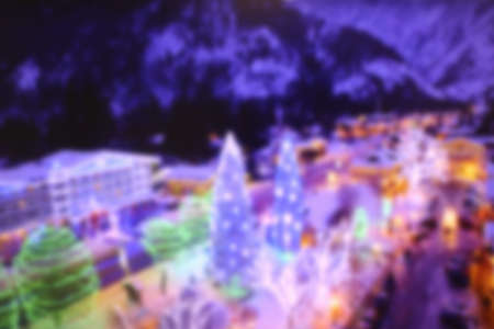 Conceptual defocused abstract decorated christmas tree and crowd of people on city street at nightの写真素材