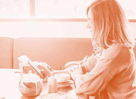 beautiful girl sitting in cafe holding a smartphone. Time for coffee, smart man using a mobile phone in a cafe,の写真素材