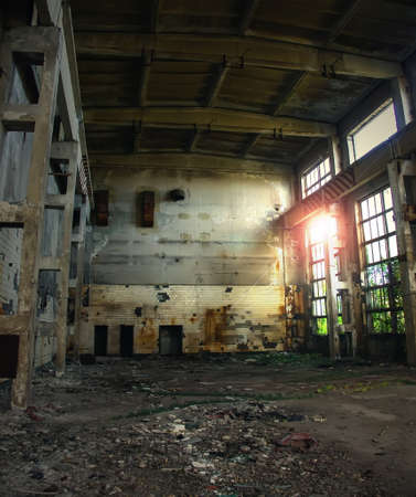 Large abandoned industrial hall. Dangerous area. Abandoned industrial interior with bright lights. Exclusion zone, radiation risk, lost city, apocalyptic buildingの写真素材