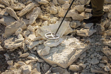 man with a metal detector in search of historical values