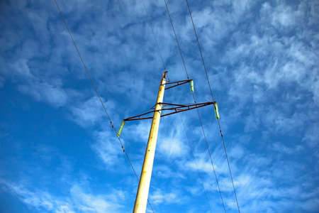 Electricity poles. rows of power lines on a blue background