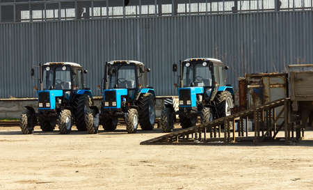 Tractors and cab harvesters. Agricultural machinery at the assembly plant. Selective focus