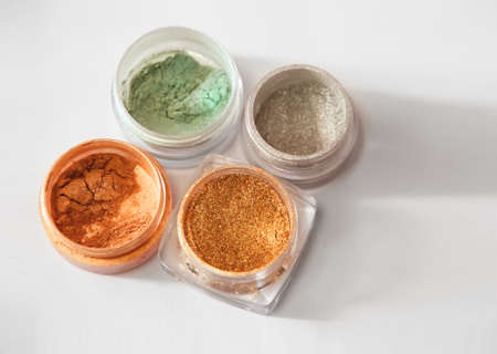 Gold glitter, shiny eye shadows. Brilliant glitter nail design on a white background, horizontalの写真素材