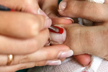 pedicure, pedicure process professional in the beauty salon, clean cuticles and nail on his feet,...