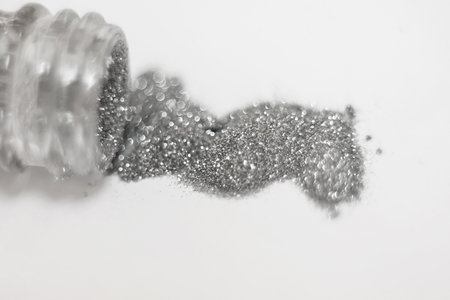 silver sequins. a scattering of silver glitter texture and background, pours from the bottle horizontal, shallow depth of fieldの写真素材